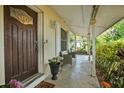 Welcoming front porch features comfortable seating and lush greenery, creating a relaxing outdoor space at 1090 Wakefield Cir, Deltona, FL 32725