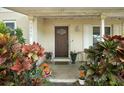 Inviting front porch adorned with vibrant foliage, leading to an attractive front door at 1090 Wakefield Cir, Deltona, FL 32725