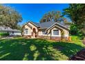 Charming home exterior with a well-manicured lawn, landscaping, stone accents, and a welcoming entrance at 1309 Wicklow Ln, Ormond Beach, FL 32174