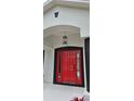 Stylish front entrance with a red door and black decorative lighting fixture above at 1568 Pendleton St, Deltona, FL 32725