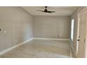 Bright living room featuring marble floors, neutral paint, a ceiling fan and a front door entrance at 1568 Pendleton St, Deltona, FL 32725