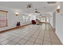 Spacious living room with tile flooring, recessed lighting, ceiling fans, and large windows providing natural light at 1590 Urbana Ave, Deltona, FL 32725