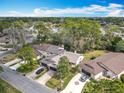 Scenic aerial view of a neighborhood with mature trees, well-kept homes, and paved streets at 16 Big Buck Trl, Ormond Beach, FL 32174