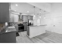Modern kitchen with stainless steel appliances, granite countertops, and a stylish backsplash at 1626 Lansfield Ave, Deltona, FL 32738