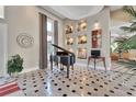 Elegant foyer with decorative shelving and stylish accents, piano, marble tile flooring, and tray ceilings at 183 Mcgregor Rd, Deland, FL 32720