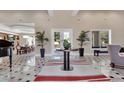 Grand foyer with decorative rug, marble tile flooring, tray ceilings and bright natural light from the front door at 183 Mcgregor Rd, Deland, FL 32720