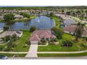 Beautiful aerial shot of house and neighborhood with a lake, fountain, and well kept lawns at 1860 Forough Cir, Port Orange, FL 32128