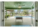 Covered back porch view of screened in pool with a lake in the background at 1862 Shelby Ter, Deltona, FL 32725