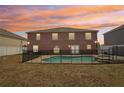 Beautiful backyard featuring a fenced in pool and hot tub with a view of neighboring houses at 193 Fish Hawk Dr, Winter Haven, FL 33884