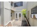 Private patio featuring double doors, and an air conditioning unit at 207 Pine Cone Trl, Ormond Beach, FL 32174