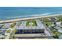 Stunning aerial perspective of Ormond Breakers Condominium complex, pool, and beachfront at 2100 Ocean Shore Blvd # 1120, Ormond Beach, FL 32176