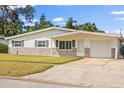 Charming single-story home featuring stone accents, attached garage, and well-maintained lawn at 2144 Brian Ave, South Daytona, FL 32119