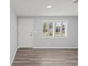 Bright living room with new wood floors and plantation shutters at 2144 Brian Ave, South Daytona, FL 32119