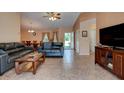 Spacious living room with tile flooring, comfortable seating, and a view of the adjacent dining area at 2213 Needle Palm Dr, Edgewater, FL 32141