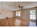 Bright living room featuring wood-look floors and a stylish ceiling fan at 2214 Danforth Ave, Deltona, FL 32738