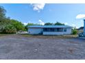 The back of the home has a large yard, a screen room and plenty of extra parking at 2214 Danforth Ave, Deltona, FL 32738