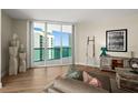 Well-lit living room with chic decor, wood-style flooring, and sliding glass doors with beautiful views at 231 Riverside Dr # 2310, Holly Hill, FL 32117