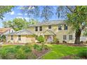 Two-story home with mature trees and a beautiful lawn at 28 Shadowcreek Way, Ormond Beach, FL 32174