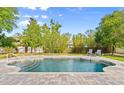 Backyard in-ground swimming pool with a brick paver surround at 28 Shadowcreek Way, Ormond Beach, FL 32174