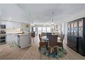 Open dining area with stylish table set, modern light fixture and scenic view beyond at 2967 S Atlantic Ave # 1404, Daytona Beach, FL 32118