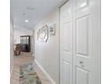 Well-lit hallway showcasing neutral walls, wood floors, and a spacious storage closet at 2967 S Atlantic Ave # 1404, Daytona Beach, FL 32118