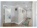 Bright hallway featuring wood flooring, decorative mirrors and direct access to the bathroom at 2967 S Atlantic Ave # 1404, Daytona Beach, FL 32118
