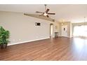 Open living room features vaulted ceilings, modern ceiling fan, and wood-look flooring at 3025 Bonkirk Dr, Deltona, FL 32738