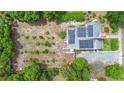 Overhead view of home featuring solar panels and a large backyard garden with circular planting beds at 333 N Kentucky Ave, Deland, FL 32724
