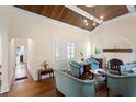 Charming living room with a wood-paneled ceiling, a fireplace, and cozy seating arrangement at 333 N Kentucky Ave, Deland, FL 32724