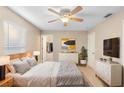 Serene bedroom features a ceiling fan, neutral decor, and a walk-in closet at 333 Redwood Ave, Orange City, FL 32763
