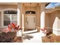 Welcoming front door framed by decorative pillars and lush landscaping at 41 Ormond Green Blvd, Ormond Beach, FL 32174