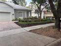 View of landscaped front yard showcasing green bushes and a manicured lawn at 417 Victoria Hills Dr, Deland, FL 32724