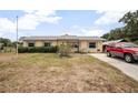 A well-maintained one-story home with a car in the driveway and large front yard at 441 E Kicklighter Rd, Lake Helen, FL 32744