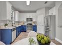 Well-lit kitchen with stainless steel appliances, two-tone cabinets, and granite countertops at 486 Sycamore Springs St, Debary, FL 32713