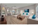 Bright living room featuring contemporary furniture, light wood floors, and an open floor plan at 486 Sycamore Springs St, Debary, FL 32713