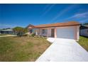Exterior of a single-story house featuring a well-manicured front lawn and a driveway at 5519 Silent Brook Dr, Orlando, FL 32821