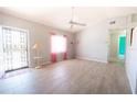 Bright living room with tile floors, ceiling fan, and a view to front door at 5519 Silent Brook Dr, Orlando, FL 32821