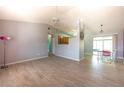 Open living room boasts neutral tile floors and a view of the kitchen and dining area at 5519 Silent Brook Dr, Orlando, FL 32821