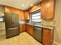 The spacious kitchen features stainless steel appliances, granite countertops, and ample cabinet space for storage at 600 S Parkview Ave, Orange City, FL 32763