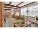 Bright and airy living room featuring wood beam ceilings, large windows, and an open floor plan at 601 N Garfield Ave, Deland, FL 32724