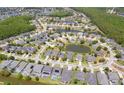 Expansive aerial view of a community featuring lush landscaping and multiple ponds at 6917 Vintage Ln, Port Orange, FL 32128