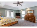 Main bedroom with tray ceilings, access to a private balcony, and large dresser at 10 Foxhunter Flt, Ormond Beach, FL 32174