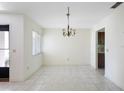 Bright living area with neutral tile flooring, chandelier, and a window that allows ample natural light at 101 Grand Plaza Dr # G30, Orange City, FL 32763