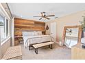 Comfortable main bedroom with wood accent wall, ceiling fan, and a light and airy ambiance at 1020 Hornbeam St, Oviedo, FL 32765