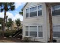 A well maintained condo with black stairs, multiple windows, and palm trees in a community at 1083 S Hiawassee Rd # 611, Orlando, FL 32835