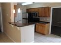 A kitchen featuring modern stainless steel appliances, beautiful granite counters, and ample cabinet space at 1083 S Hiawassee Rd # 611, Orlando, FL 32835