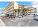 Exterior view of a resort featuring multiple stories, palm trees, and convenient parking at 1233 N Atlantic Ave # 3090, Daytona Beach, FL 32118
