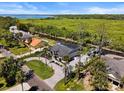 Aerial view of neighborhood home with waterfront access and lush greenery at 1446 Stone Trl, Enterprise, FL 32725