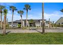Beautiful front yard with meticulously kept landscaping and a long driveway leading to a stunning home at 1446 Stone Trl, Enterprise, FL 32725