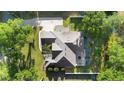 Birds-eye view of a well-maintained property showcasing the roof, driveway, and landscaping at 1523 Red Plum Holw, Deland, FL 32720